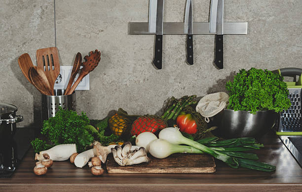 istock Fresh vegetables and herbs on a countertop in a modern kitchen, ready for preparing healthy meals from the farmer's market 2222688591