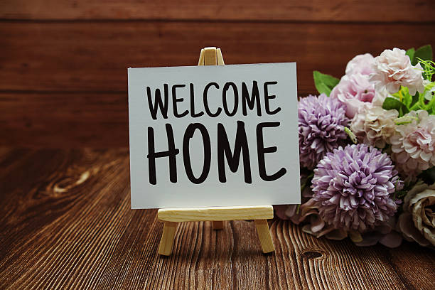 istock Welcome Home text on paper card on wooden background 2222691666