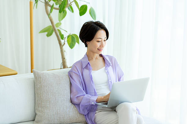 istock Middle-aged woman using a laptop in the room 2222693369