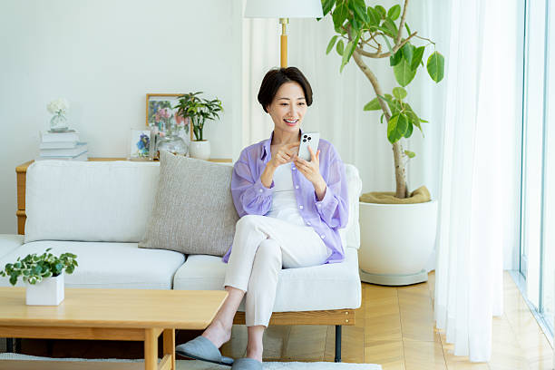 istock Middle-aged woman operating a smartphone in the room 2222693734