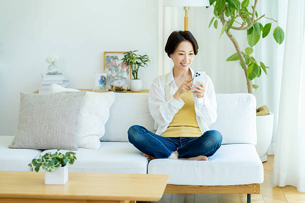 istock Middle-aged woman operating a smartphone in the room 2222693842
