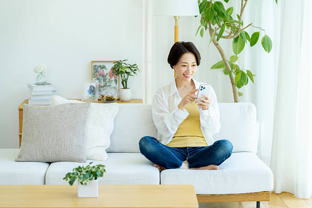 istock Middle-aged woman operating a smartphone in the room 2222693843