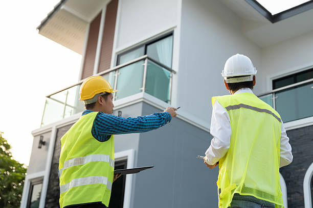 istock inspector engineer and owner project is inspecting construction and quality assurance new house. Engineers or architects or contactor work to build the house before handing it over to the homeowner 2222699288