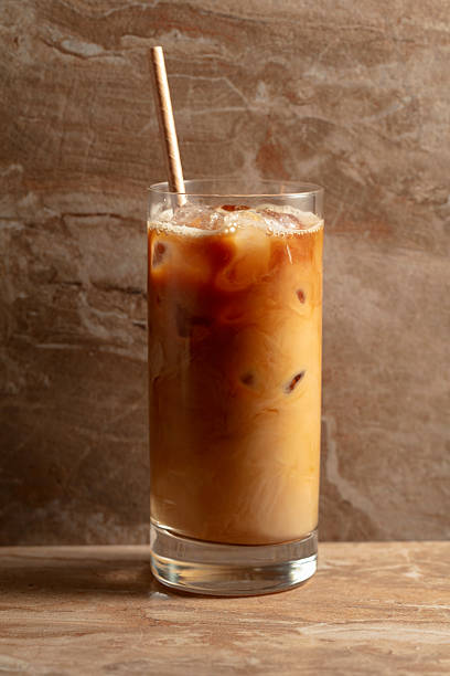 istock Iced coffee with cream on a beige ceramic table. 2222700014