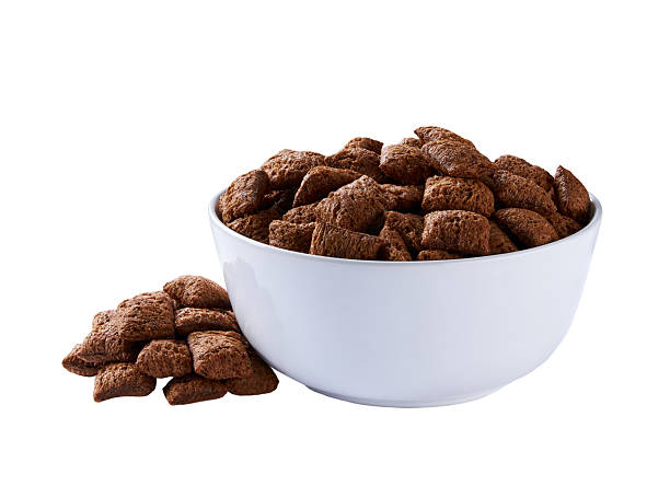 istock chocolate corn pads pouring out of plate isolated on white background. 2222701145