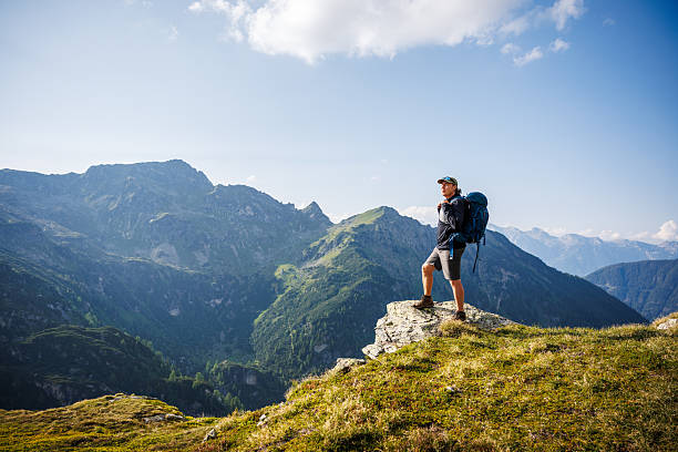 istock Solo backpacker hiking in Austrian Alps, enjoying view at mountain range after uphill climb 2222702895