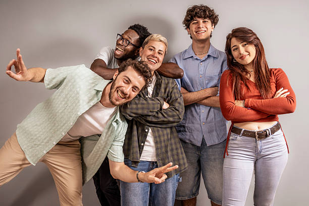 istock Five multicultural friends posing together in casual studio portrait laughing and having fun 2222707502