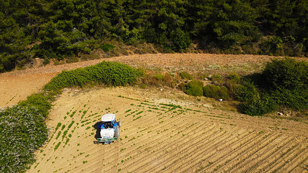 istock Overhead View of Tractor Working on Farm Field 2222708599