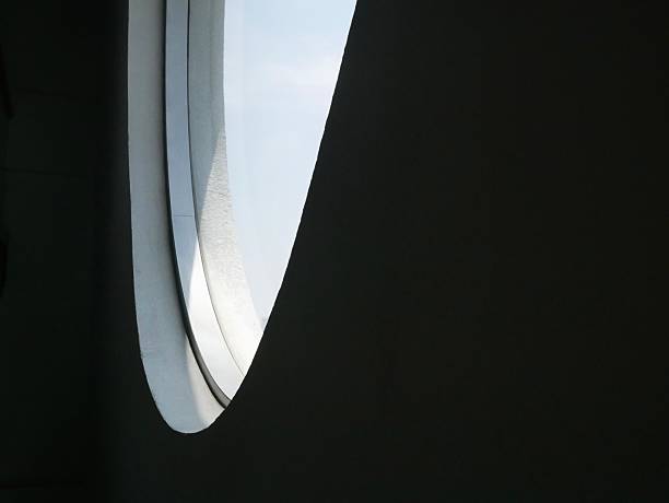 View of a circular skylight in a modern architectural interior, casting light into the space below.