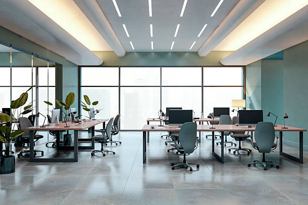 istock Modern empty coworking office interior with minimalist desk setup, ceiling lights, and city view through large backlit windows. 3D Rendering. 3D Rendering 2222712093