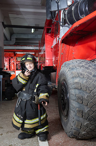 istock Attention! Fire brigade, get ready! Cute little boy firefighter talking on the radio 2222713942