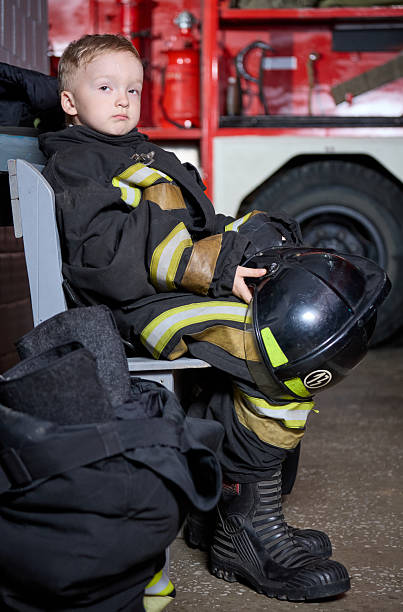 istock Little boy in firefighter clothes resting after fire alarm 2222714007
