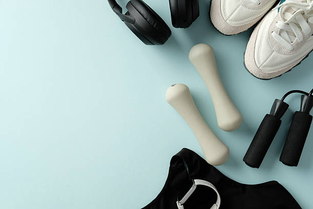 istock Fitness equipment flat lay on light blue background with copy space. 2222714795