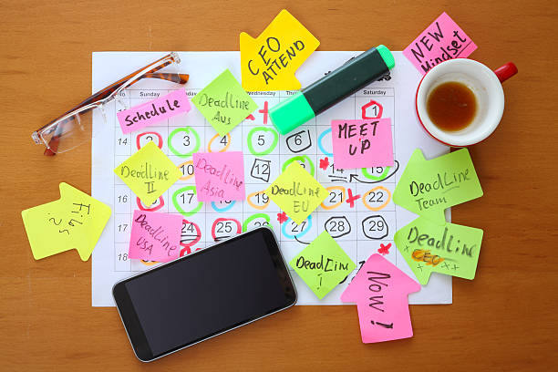 istock Calendars with business appointments, deadline notice and adhesive notes on cluttered desk. Business concept, sucess,heavy workload, innovation,ideas, carreer booster 2222721047