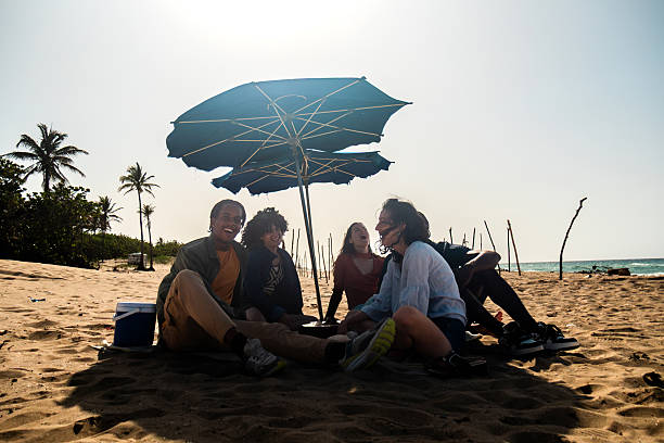 istock Young friends talking on the beach 2222725479