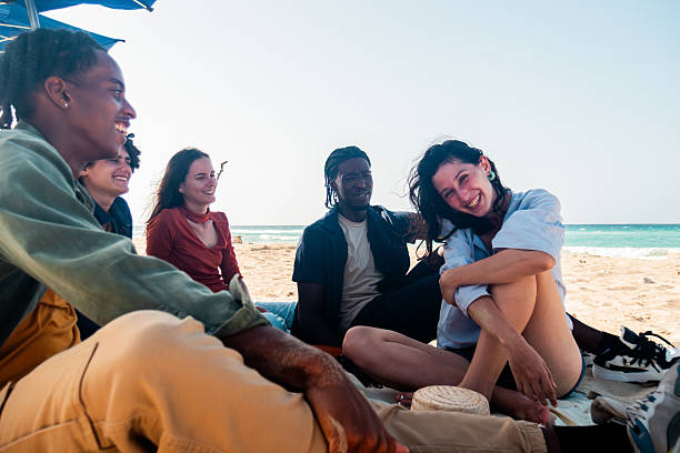 istock Young friends talking on the beach 2222725504