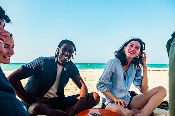 istock Young friends talking on the beach 2222725545