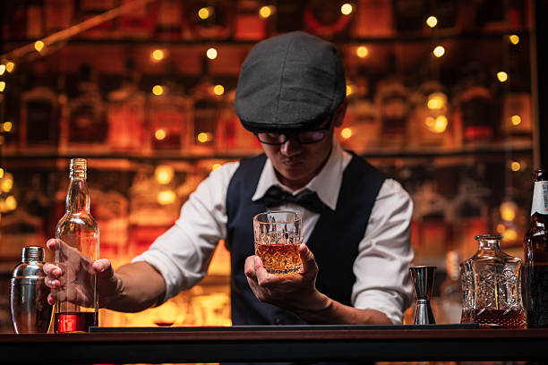 istock Bartender is pouring whiskey into a customer's glass 2222725909