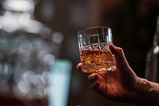istock Bartender is pouring whiskey into a customer's glass 2222725935