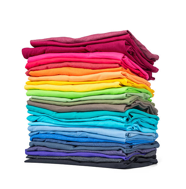 istock Stack of colorful folded t-shirts in rainbow colors, isolated on white background, path included.  Neatly arranged pile of casual cotton shirts, bright clothes for fashion, sale, or retail design. 2222726661