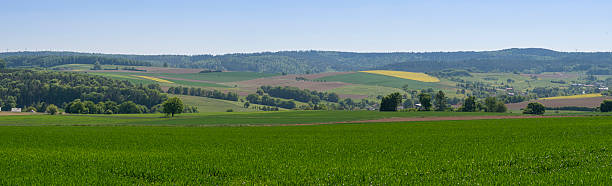 istock Panoramic view of lush farmland and rolling hills 2222730800