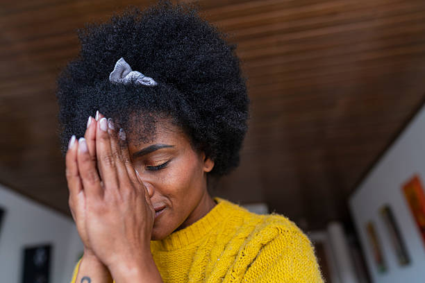 istock Beautiful African woman performs a prayer at home 2222732361