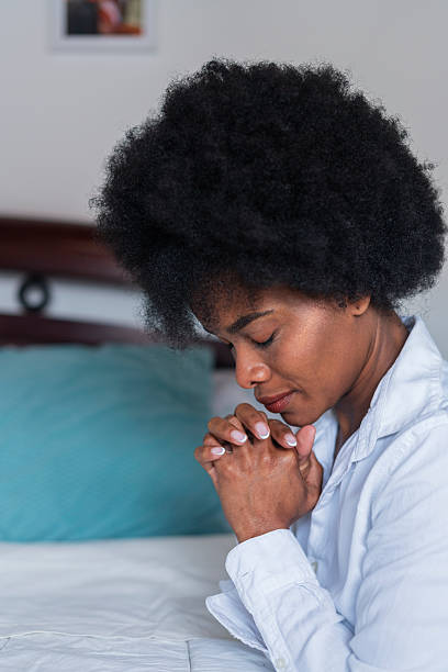 istock Beautiful African woman performs a prayer at home 2222732516
