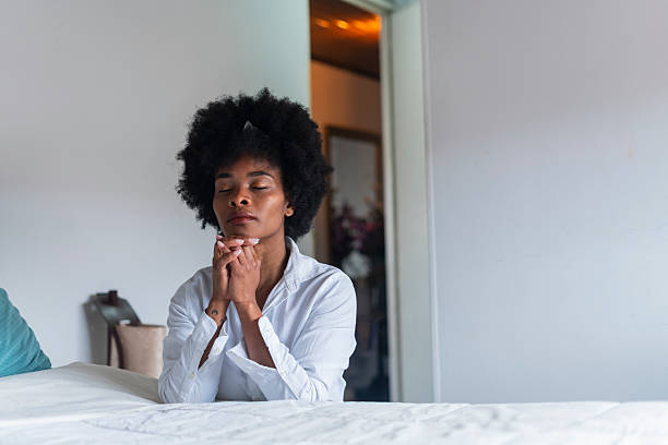 istock Beautiful African woman performs a prayer at home 2222732611