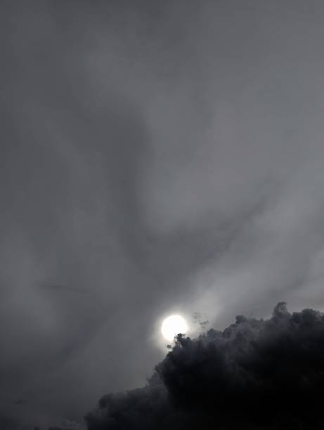 istock Ominous Sky and Sun Glimmering Through Dark Stormy Clouds 2222732986