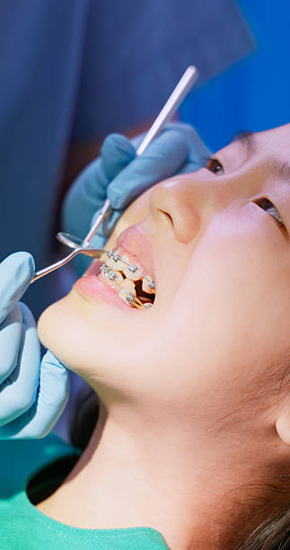 istock Asian dentist exame teenage braces status 2222733106