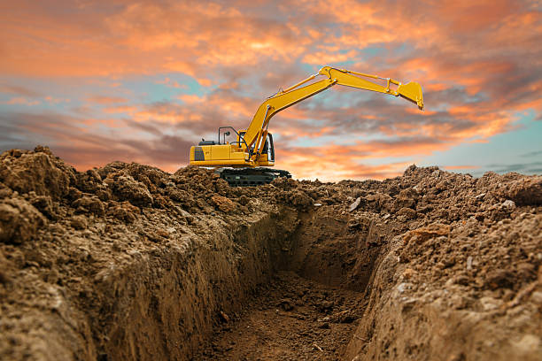 istock Excavators are digging soil with bucket lift up 2222736419