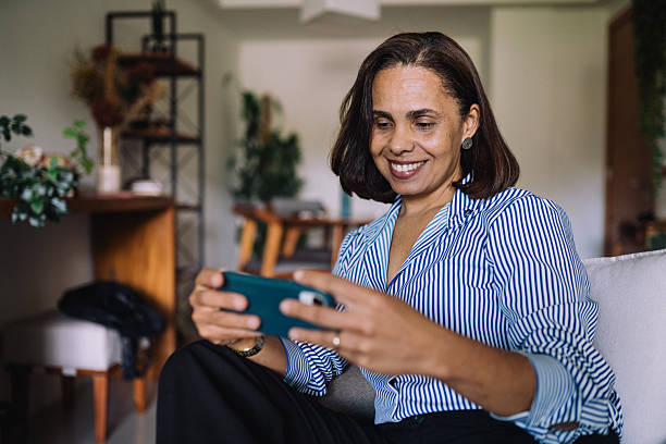 istock Woman playing mobile game at home 2222736710