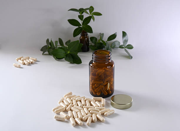 istock Capsules on the table and in an amber jar 2222743905