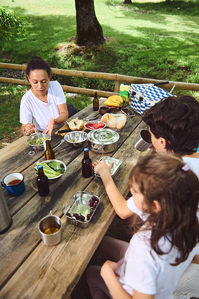 istock Family Enjoying a Relaxing Picnic Outdoors in a Scenic Nature Setting 2222749082