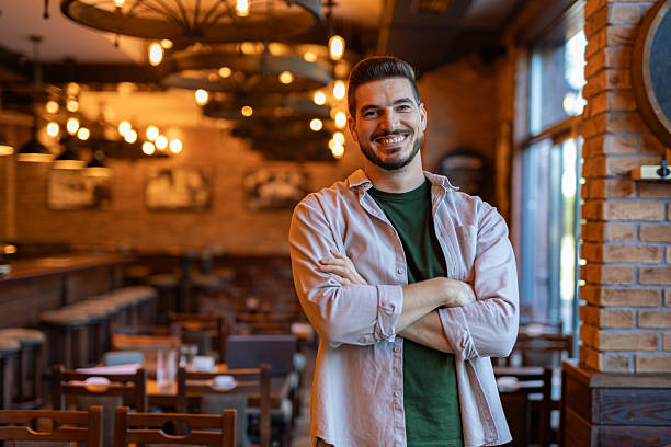 istock Restaurant manager smiling with arms crossed in his restaurant 2222752636