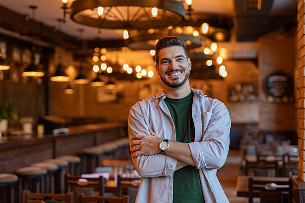 istock Restaurant manager smiling with arms crossed in his restaurant 2222752648