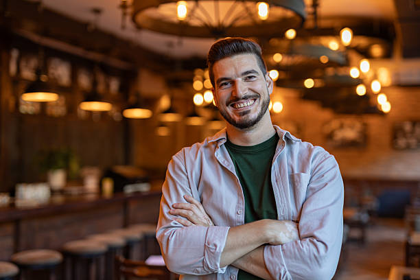 istock Confident Restaurant Manager Smiling with Arms Crossed in his Restaurant 2222752649