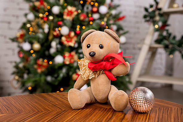 istock Plush teddy bear toy on home new year illuminations background. Christmas composition.lights in living room. 2222753489