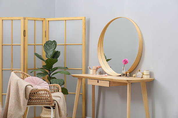 istock Mirror, dressing table, houseplant, folding screen and chair indoors. Interior design 2222754963