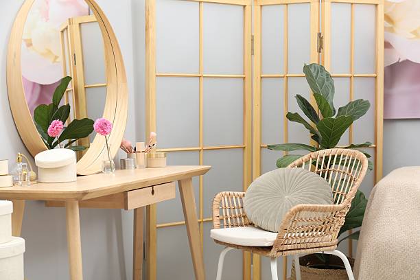 istock Mirror, dressing table, houseplant, folding screen and chair indoors. Interior design 2222754972