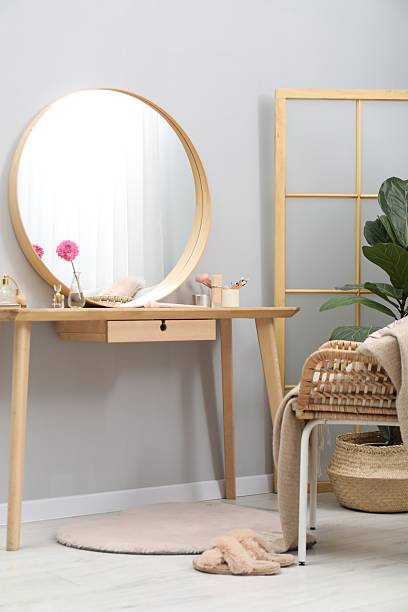 istock Mirror, dressing table, houseplant, folding screen and chair indoors. Interior design 2222754984
