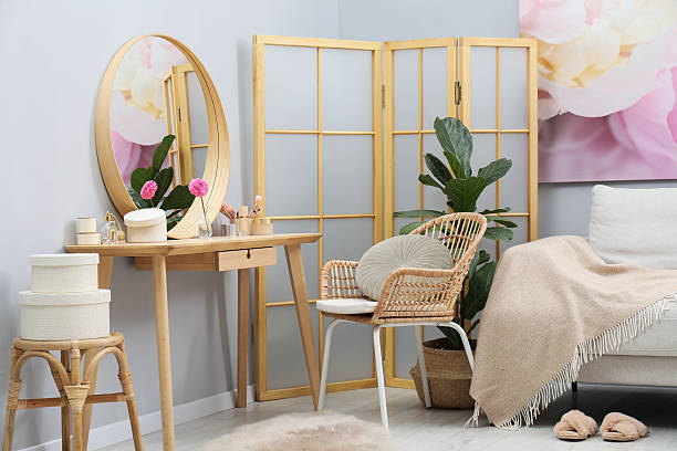 istock Mirror, dressing table, houseplant, folding screen and chair indoors. Interior design 2222755030