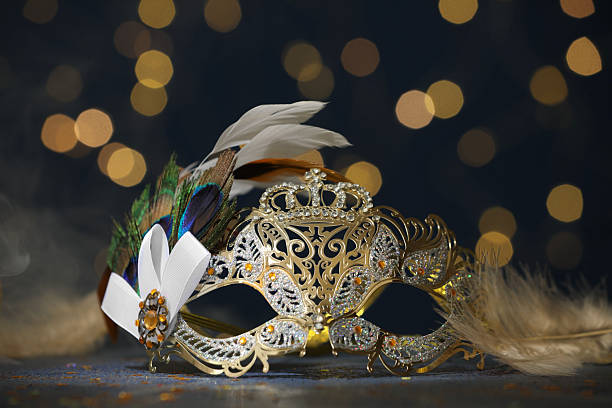 istock Beautiful carnival mask on table against dark background with blurred lights, closeup 2222755669