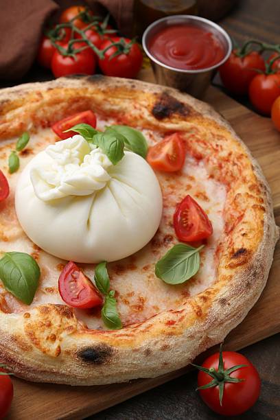 istock Delicious pizza with burrata cheese, basil, sauce and tomatoes on table, closeup 2222755897