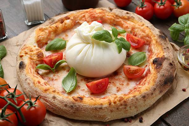 istock Delicious pizza with burrata cheese, basil and tomatoes on table, closeup 2222755976