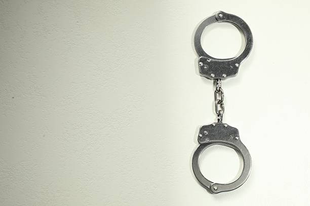 istock Classic chain handcuffs on white table, top view. Space for text 2222756346