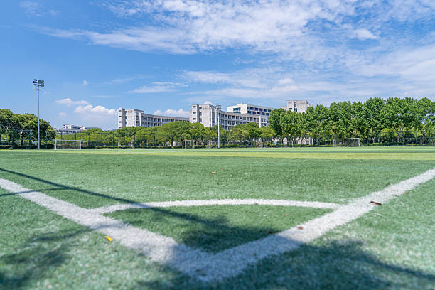 istock University campus football field under blue sky and white clouds 2222756446