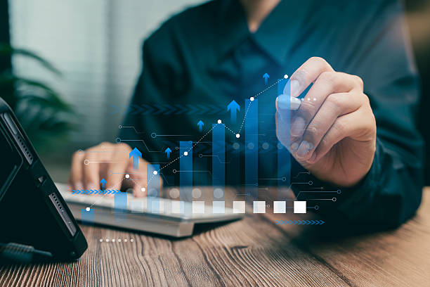 istock Business Growth. Businessperson Analyzing Growth Charts with Digital Data Visualization on Laptop in Modern Office Environment 2222756560