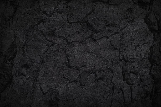 istock Texture of black concrete or tree bark background. Dark wallpaper with rough cement texture. Empty grunge wall concept or floor backdrop. Abstract surface mockup. Top view, close up, copy space 2222760090