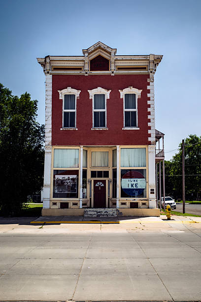 Small 2-story older commercial building in downtown Abilene, Kansas with large display windows on the ground floor featuring President Dwight D. Eisenhower memorabilia.  Eisenhower was born and raised in Abilene.  Photo taken June 27, 2019.